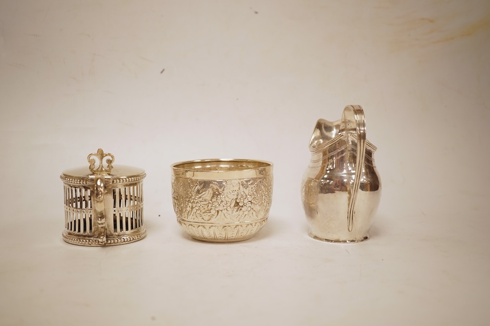 A George III silver helmet shaped cream jug, marks rubbed, 10cm(a.f.), together with a later Victorian silver sugar bowl and similar pierced silver mustard pot, no liner.